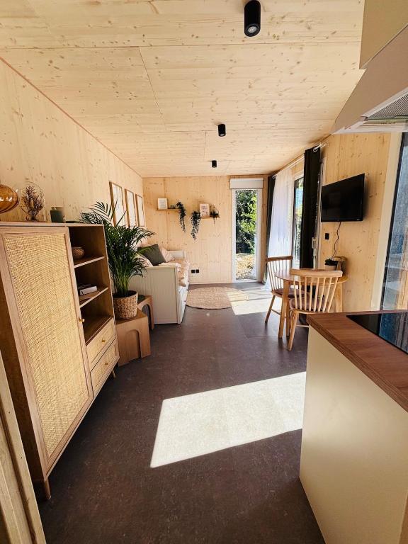 a room with a kitchen and a living room at Les Deux M Tiny House with Private Garden in Sorgues