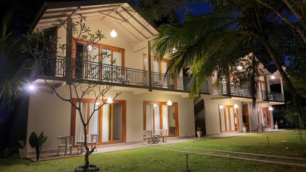 an exterior view of a house at night at Thambapanni Villa in Unawatuna