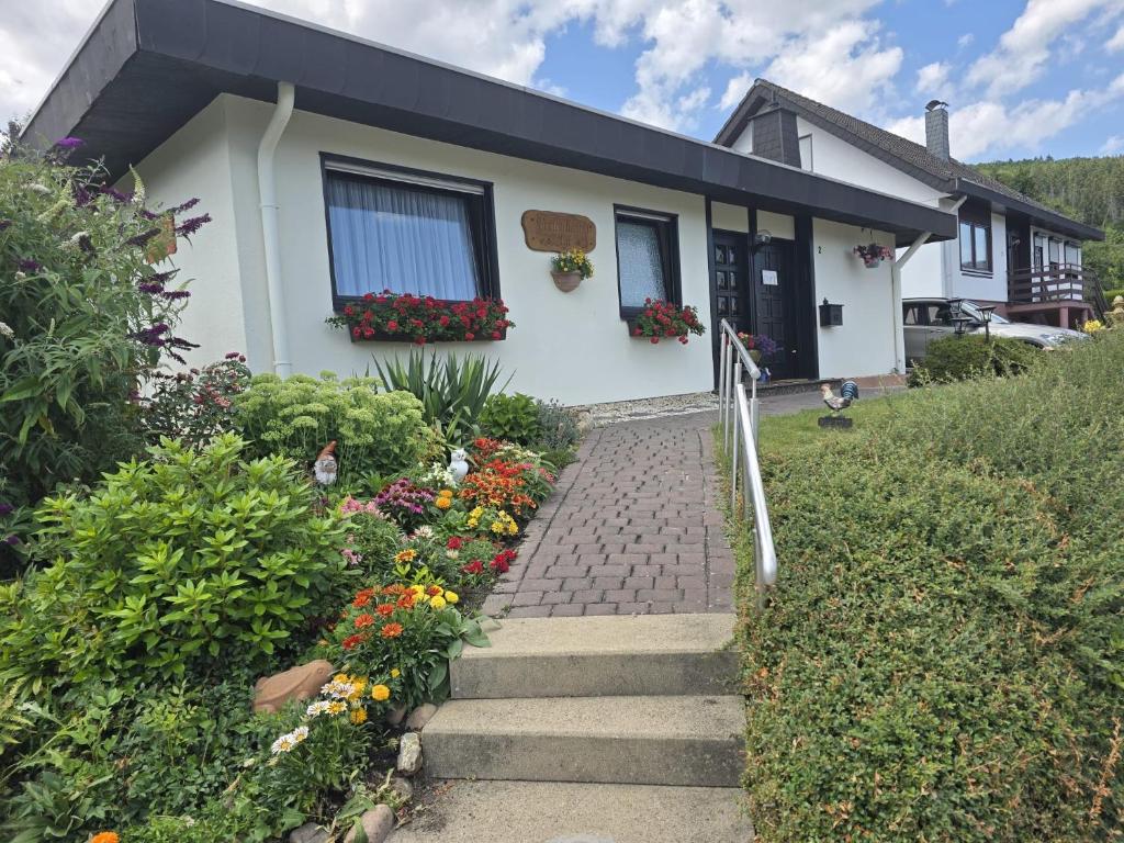 a house with flowers in front of it at Ferienhaus Agi in Schleiden