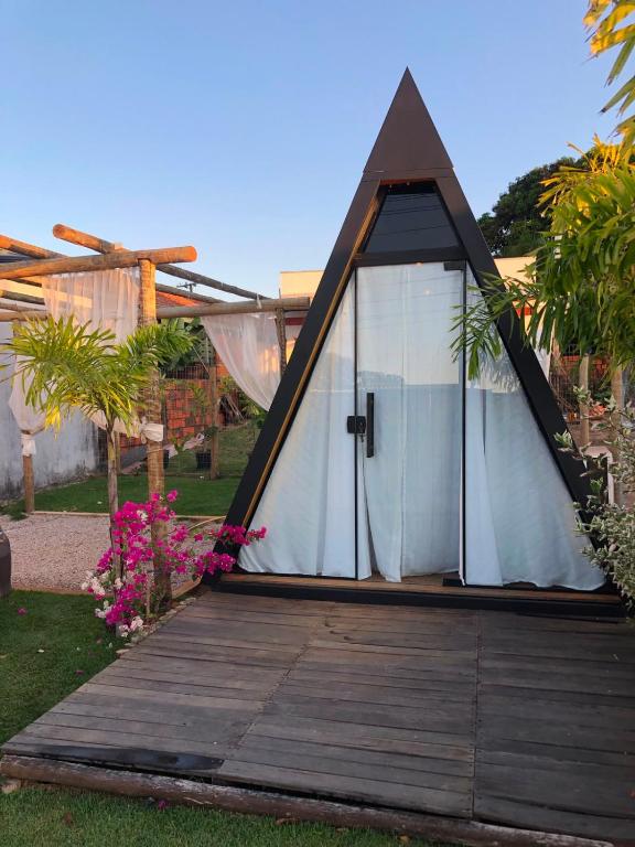 a tent with a door on a wooden deck at Chalé estilo in Chapada dos Guimarães