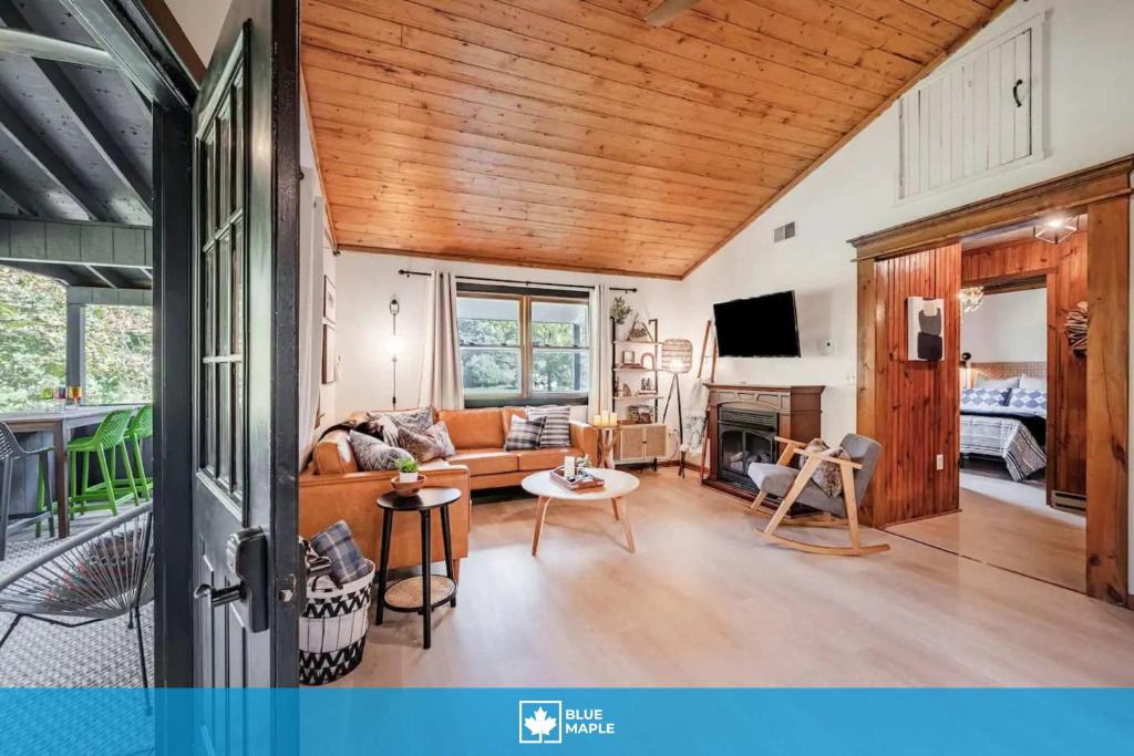 a living room with a couch and a table at Riverfront Cabin wFirepit Pool Table Porch WiFi in Hedgesville