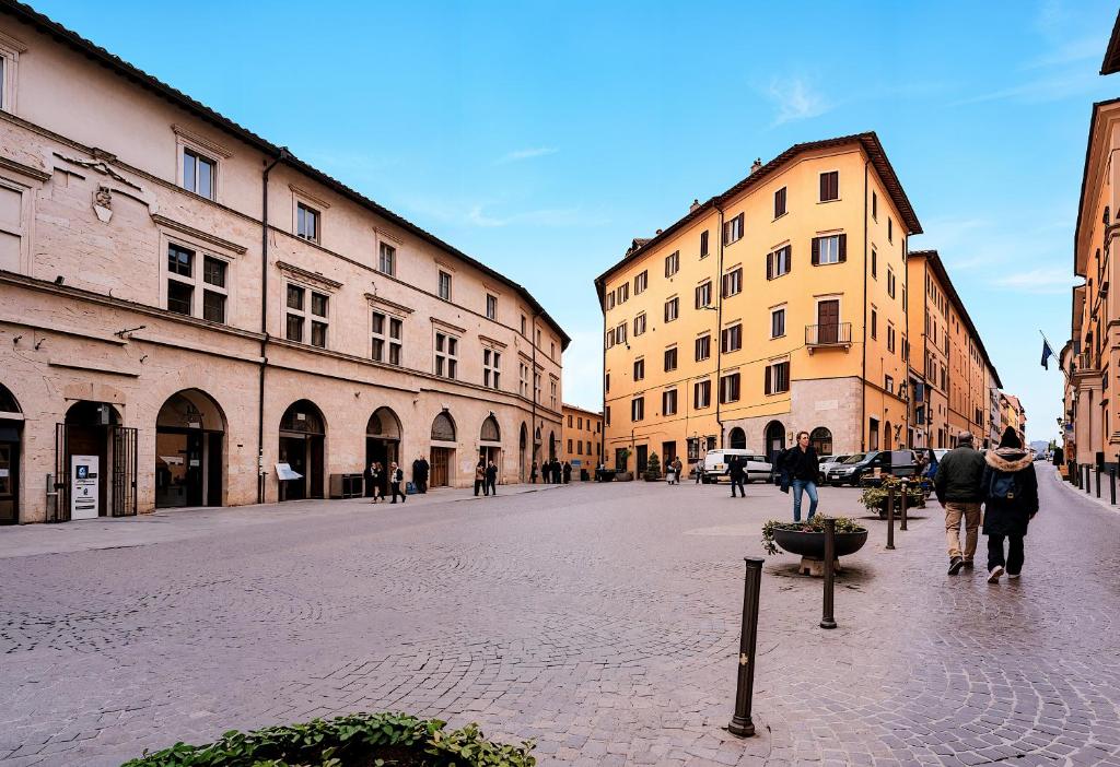 a group of people walking down a street with buildings at Baglioni Art Suite in Perugia