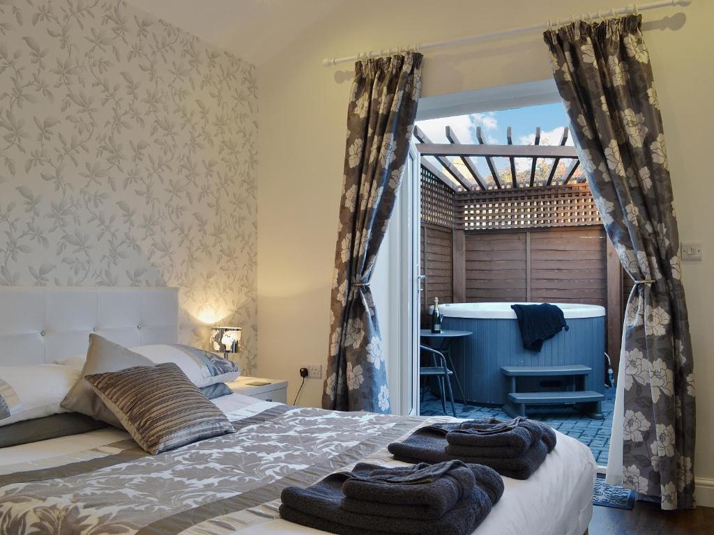 a bedroom with a bed with towels on it at Oswald Lodge in Llanon