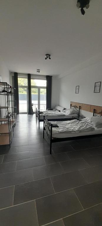 a room with three beds in a room at Apartmani Ela 2 3 in Sierning