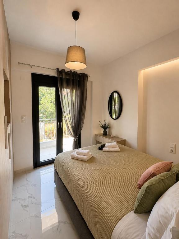 a bedroom with a large bed and a window at Skyloft Meteora 1 in Kalabaka