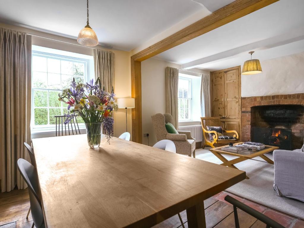 a living room with a wooden table with flowers on it at The Haven in Ludlow