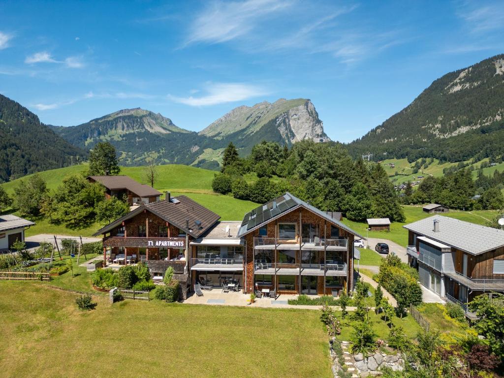 an aerial view of a house in the mountains at n Apartments Hotel in Schoppernau