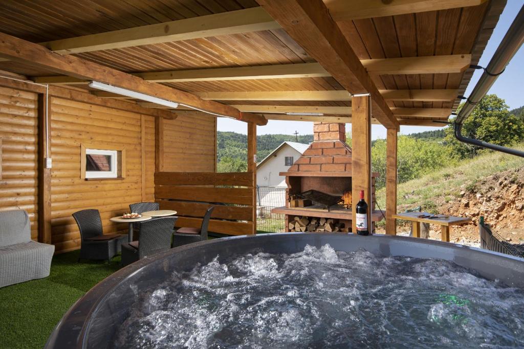 a hot tub on the patio of a house at Villa Velebita House for 9 near Plitvice Lakes in Rudopolje