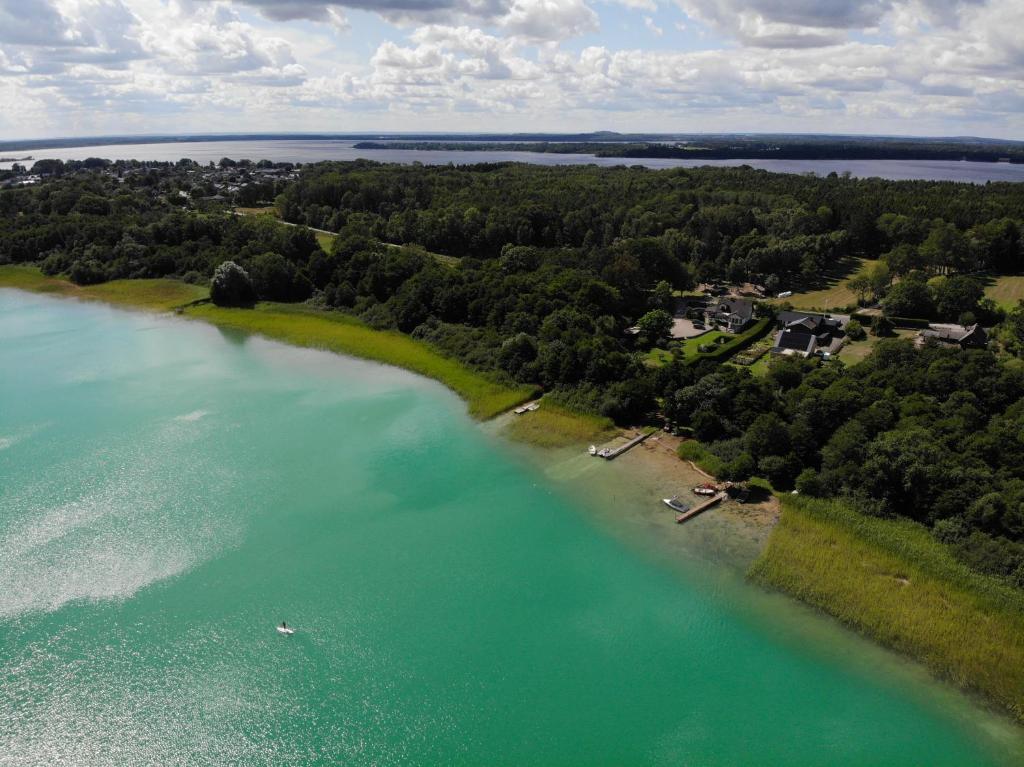 an aerial view of a lake with trees and houses at Levrasjön Lake House Private Pier in Bromölla