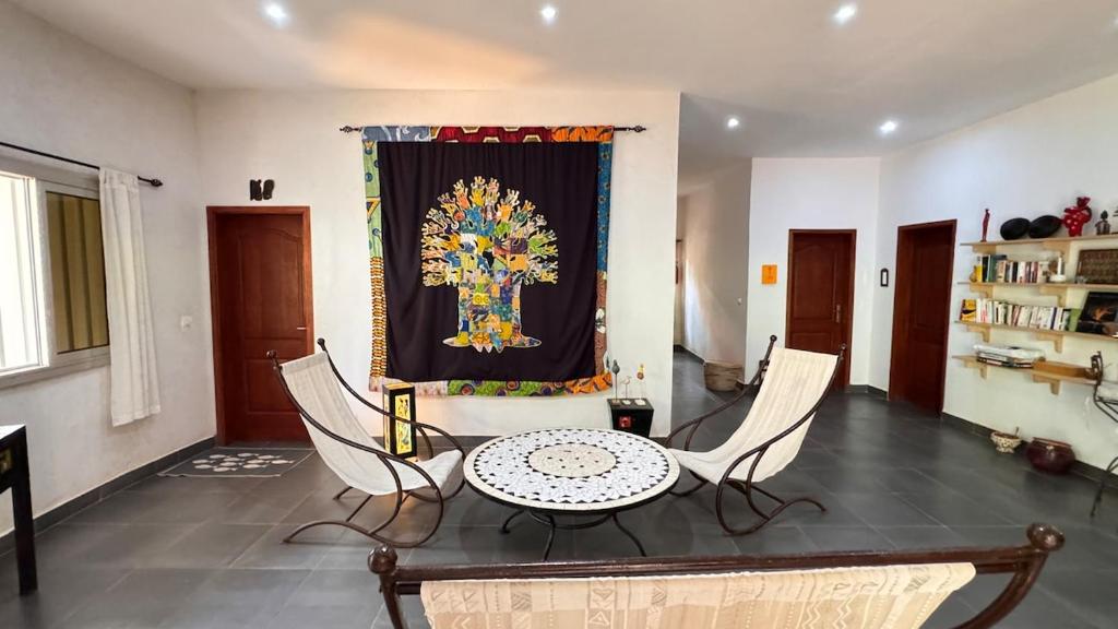 a living room with a table and chairs and a curtain at Villa La Pommone in Somone