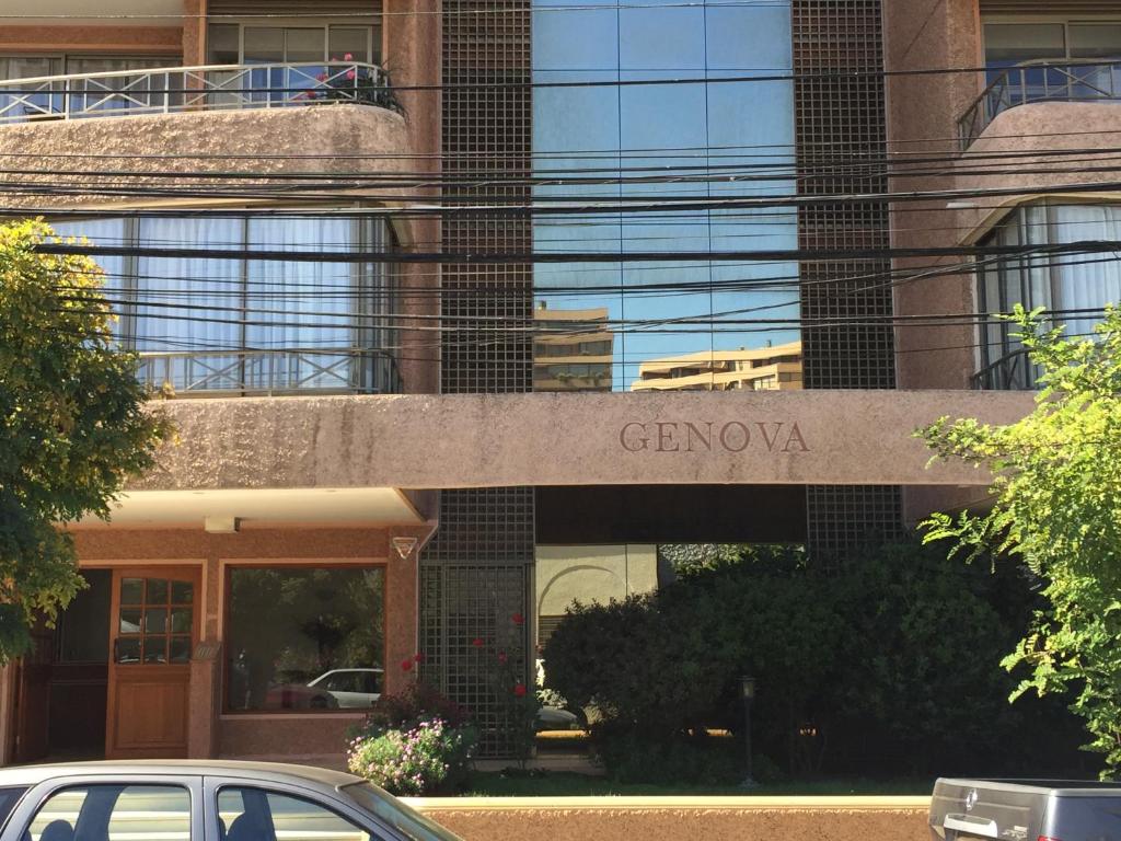 a car parked in front of a building with a sign at Apartamento Edificio Genova in Viña del Mar