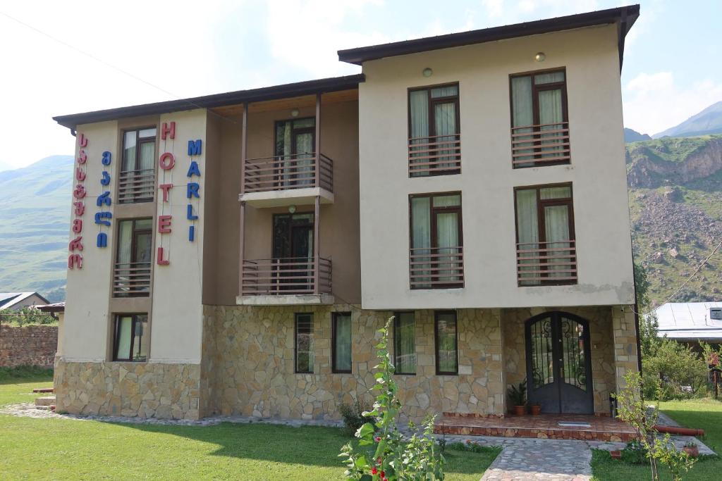 a house with a mountain in the background at Hotel Marli in Arsha