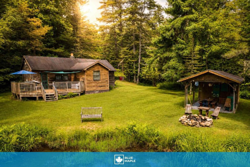 a log cabin in a yard with a gazebo at Cozy Cabin w Pavilion Deck Fireplace & FirePit in Terra Alta