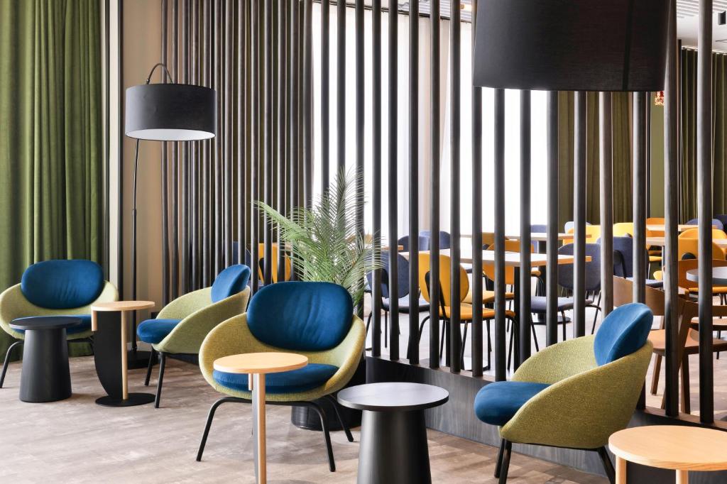a group of chairs and tables in a restaurant at B&B HOTEL Madrid San Fermin in Madrid