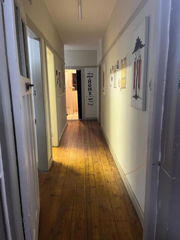 an empty hallway with a hard wood floor in a house at The Willow Whispers guest house in Gqeberha
