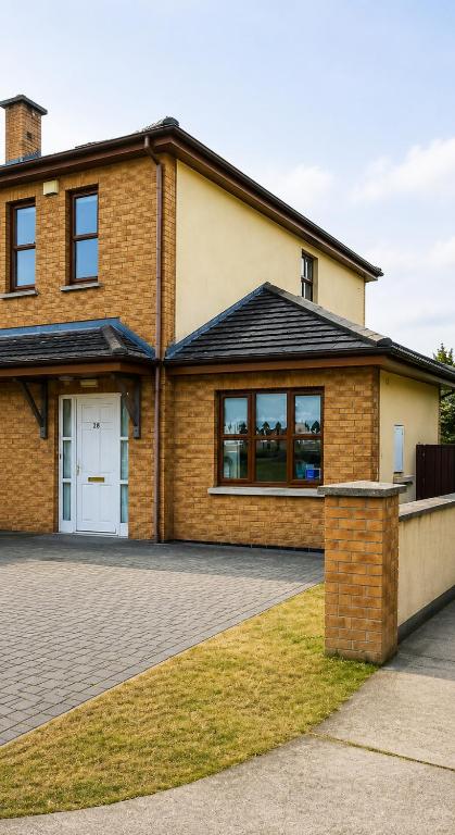 a brick house with a driveway at 28 Rathevan View Rosdarragh Portlaoise in Portlaoise