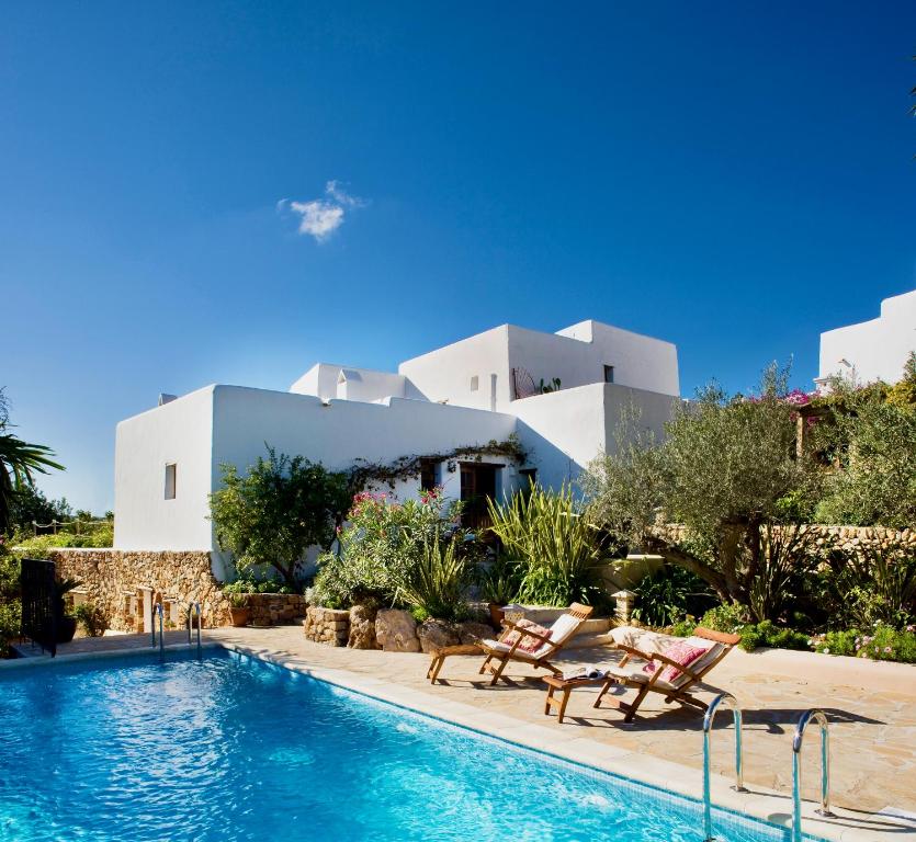 a resort with a swimming pool and a building at Can Pardal in Sant Miquel de Balansat