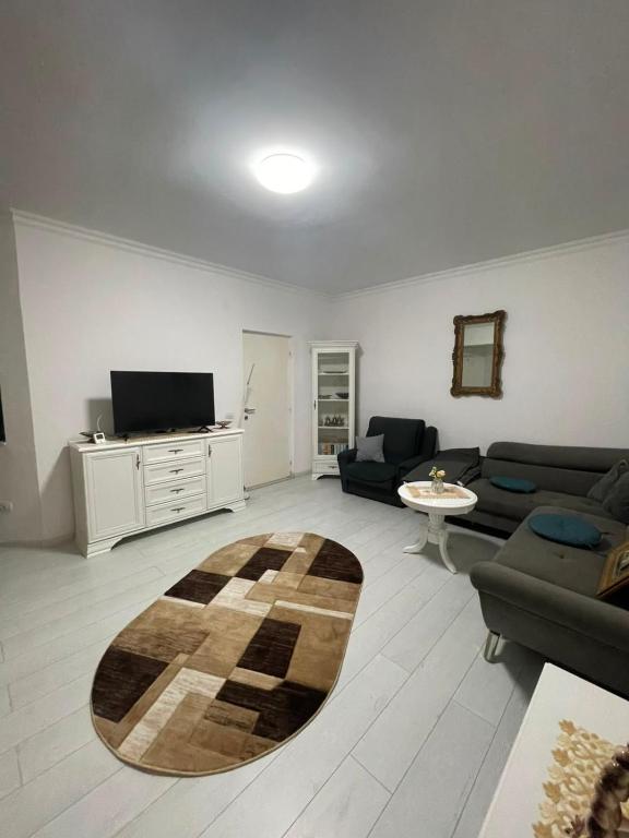 a living room with a couch and a table at Solid House Apartment - Sea View in Mamaia