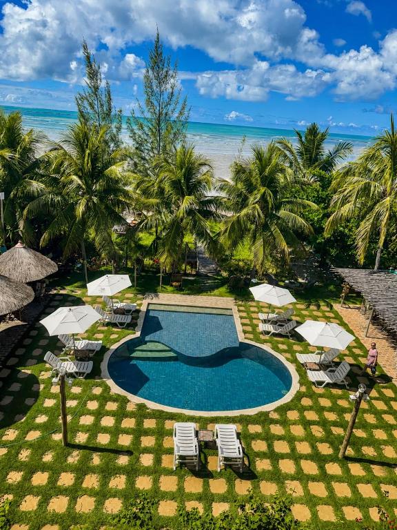 an aerial view of a resort with a swimming pool and the beach at Pousada Villa Bougainville Maragogi in Maragogi