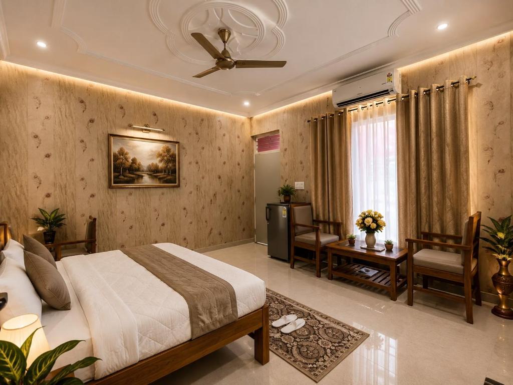 a bedroom with a bed and a table and chairs at Omkara Villa Sonipat in Sonīpat