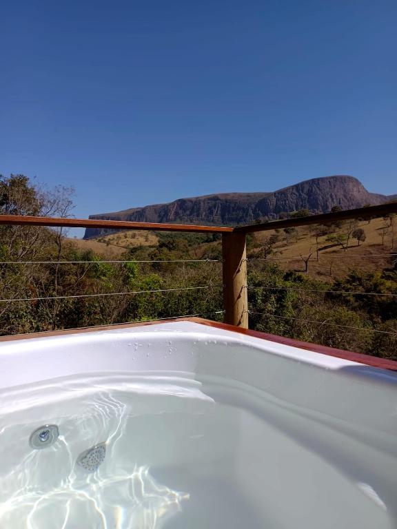a bath tub with a view of a mountain at Chalé Vertente da Canastra in São Roque de Minas