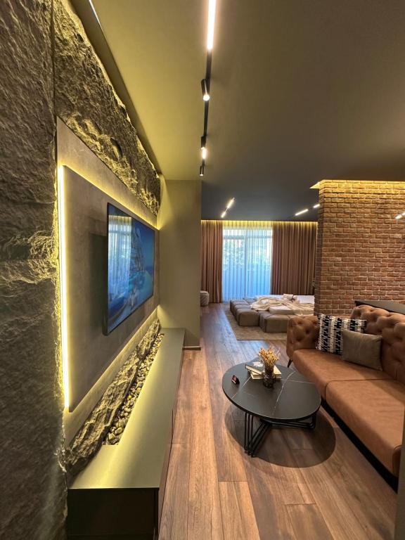a living room with a couch and a table at MOCCA Lux Suite in Bitola