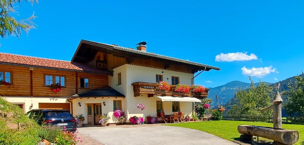 a large white house with flowers on the balcony at Apartment Wegmo in Bischofshofen