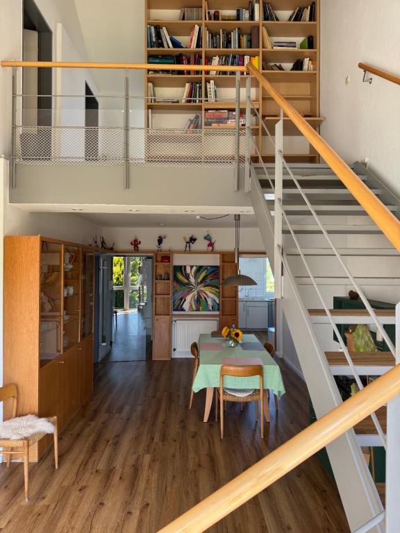 a room with a table and a staircase at Fewo Bad Salzuflen in Bad Salzuflen