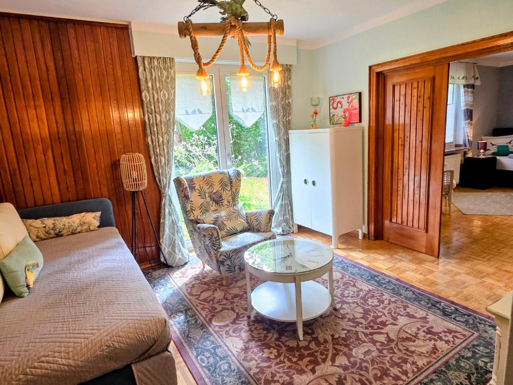a living room with a couch and a table at HR Townhouse Honigbach in Coesfeld