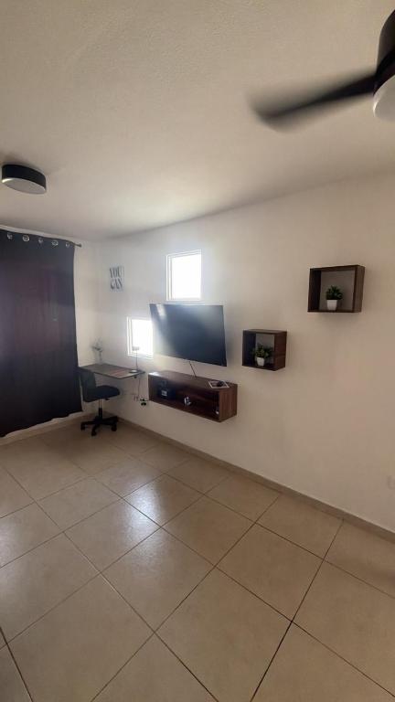 a room with a flat screen tv on a wall at Executive Apartment for 6 people in El Colorado