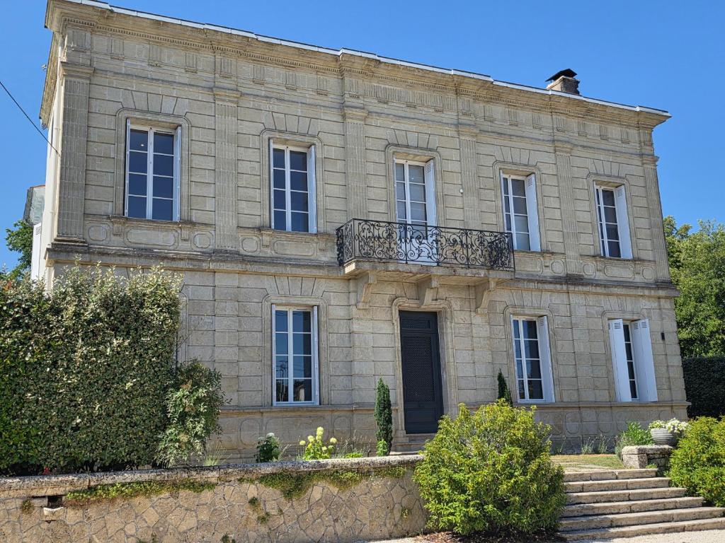 an old stone building with a balcony on top of it at Villa Aestival in Saint-Symphorien