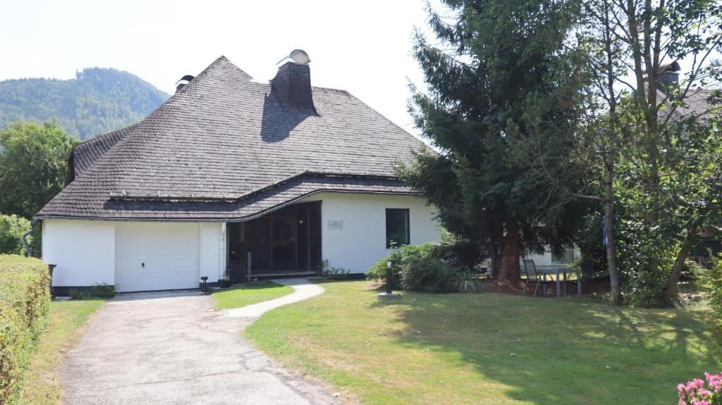 a white house with a gray roof and a driveway at Glöcknerhaus in Sankt Gallen