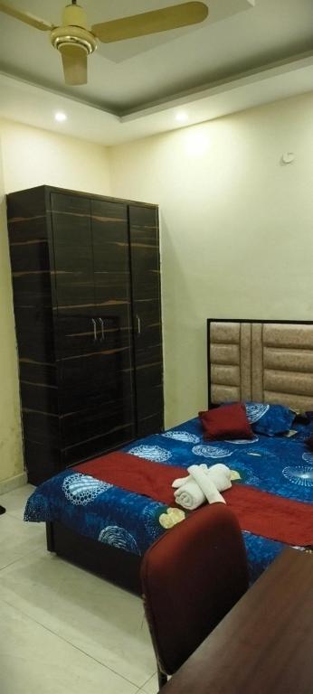 a bedroom with a bed with two towels on it at The duggar villa in Jammu