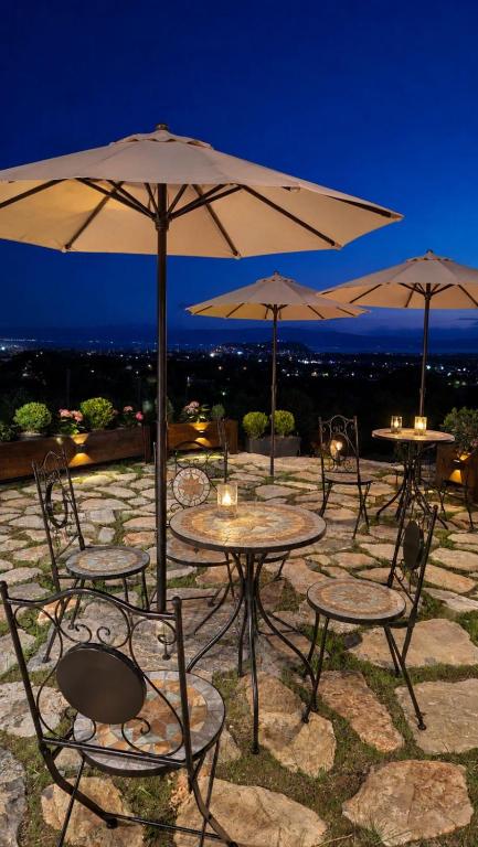 a group of tables and chairs with umbrellas at Wine House Churilo in Ohrid