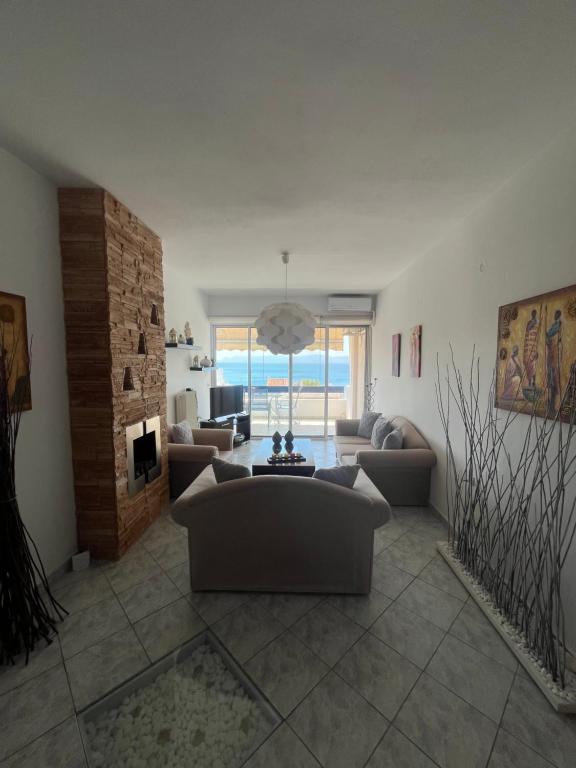 a large living room with couches and a fireplace at Paradise House in Lefkandi Chalkidas