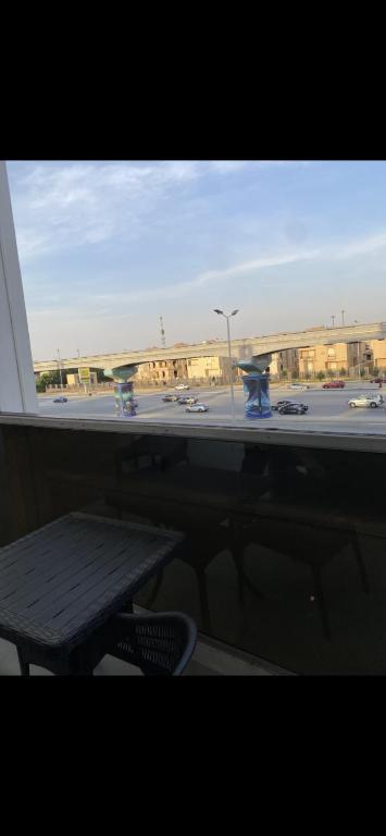 a window with a table and a view of a parking lot at Tetou Hotel Cairo in Cairo