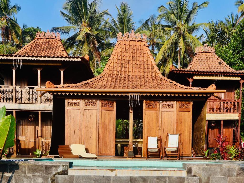 a house with chairs in front of it at Villa Hola Agung in Karangasem