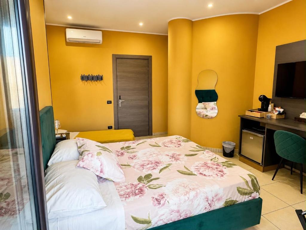 a bedroom with a bed in a room with yellow walls at Oasi Urbana in Casoria