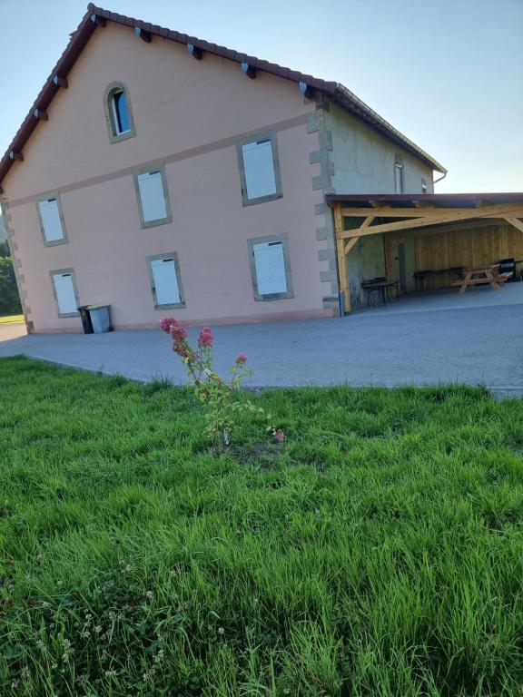 a large white building with a garage at Chez Remi in Esmoulières