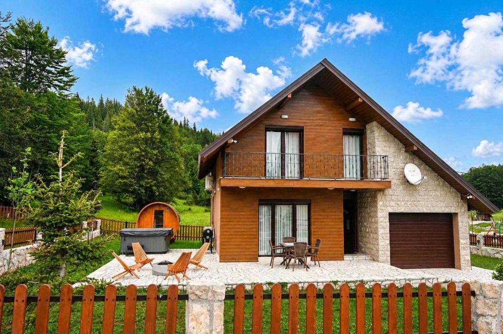 a house with a fence in front of it at North Forest in Žabljak