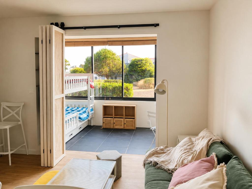 a living room with a couch and a large window at Le Spot - Capbreton - Au calme et à deux pas de la mer in Capbreton