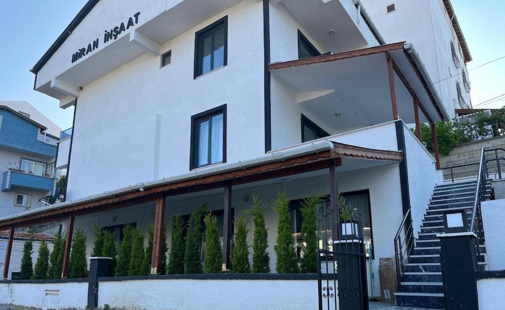a large white building with glass windows and stairs at Ege Naz 1 in Marmara
