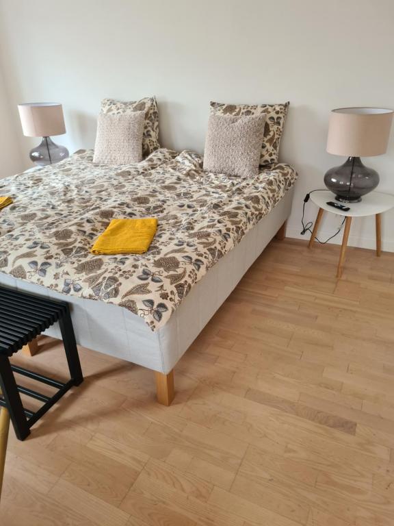 a bedroom with a bed and a wooden floor at Damm Hotell in Frederikshavn