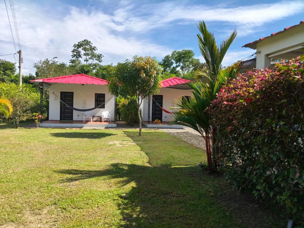 a house with a red roof and a yard at Ryhumaka in Guamal