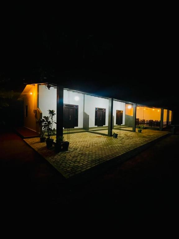a building at night with a plant in the middle at wild elephant reach wilpattu in Nochchiyagama