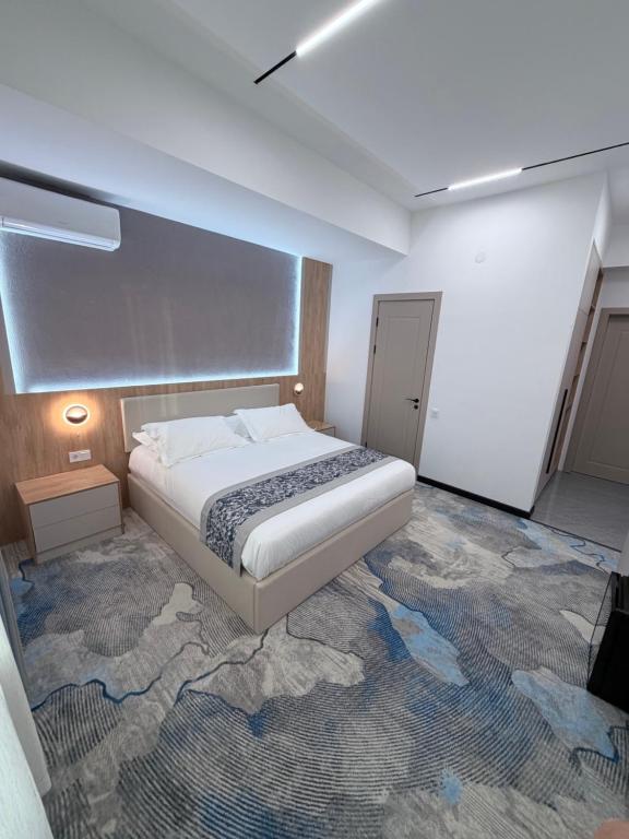 a bedroom with a bed in a room with a carpet at Keruen in Almaty