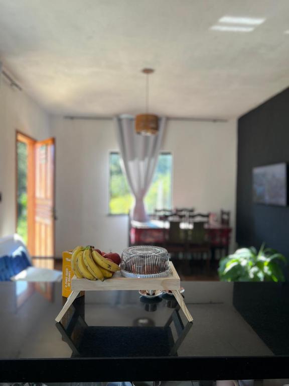 a table with bananas on it in a living room at Casa do Bosque in Paty do Alferes