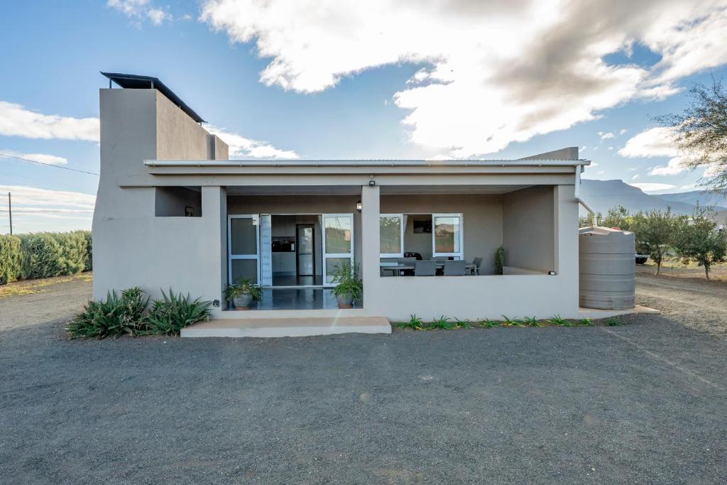 a rendering of a house with a driveway at Donkieshoek Accommodation & Campsite, Welgemoed Street, Calvinia in Calvinia