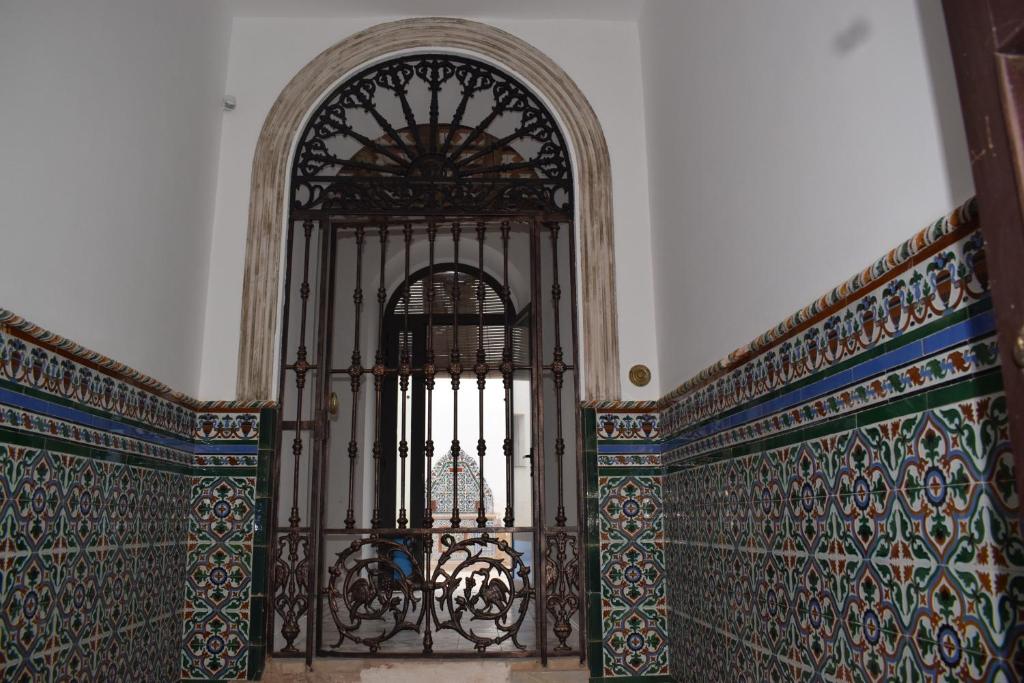 an ornate gate in a room with a wall at El patio de Carmen in Hornachuelos