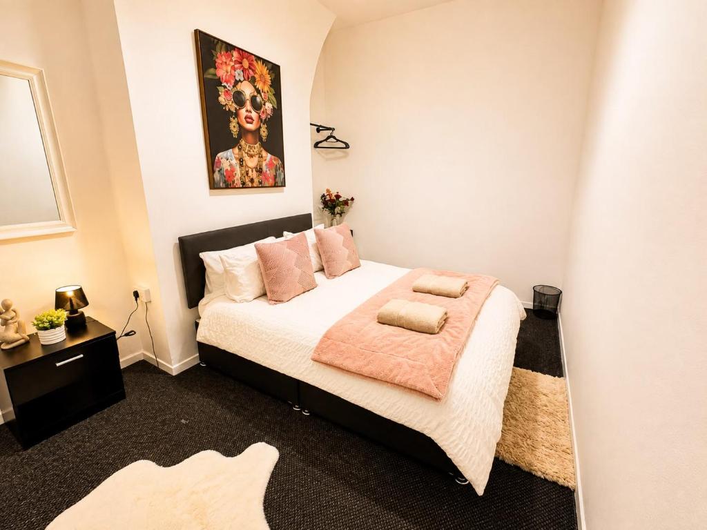 a bedroom with a bed with a pink blanket at Room 2 Shared House 10 min from Center in Liverpool